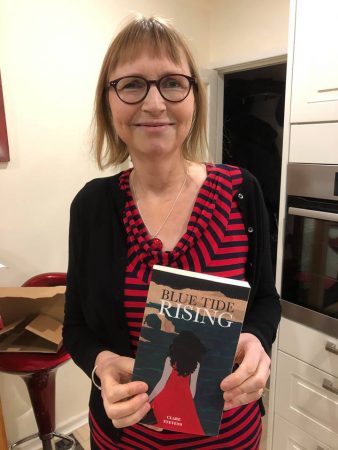 Clare Stevens, holding a copy of Blue Tide Rising